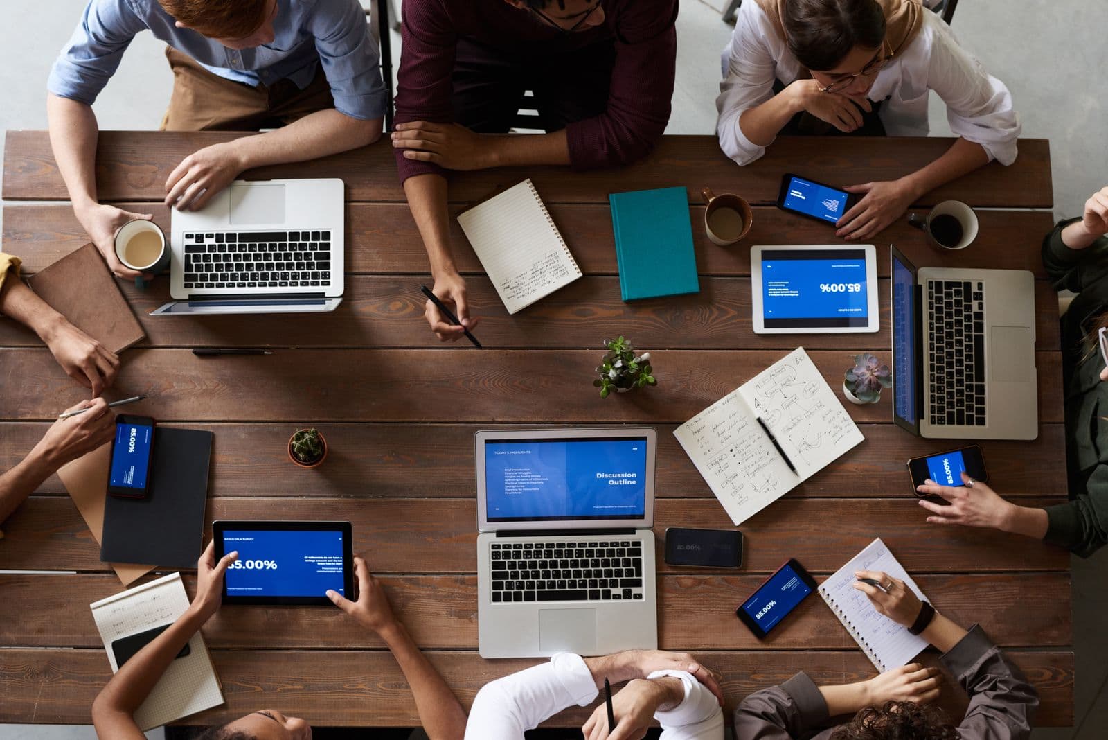 Team collaborating in a meeting with laptops